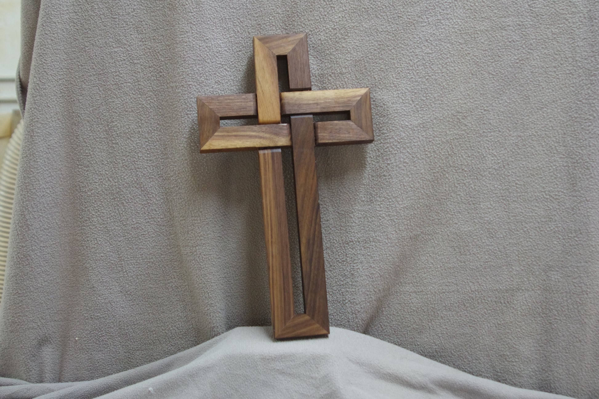 Wooden cross on a gray background