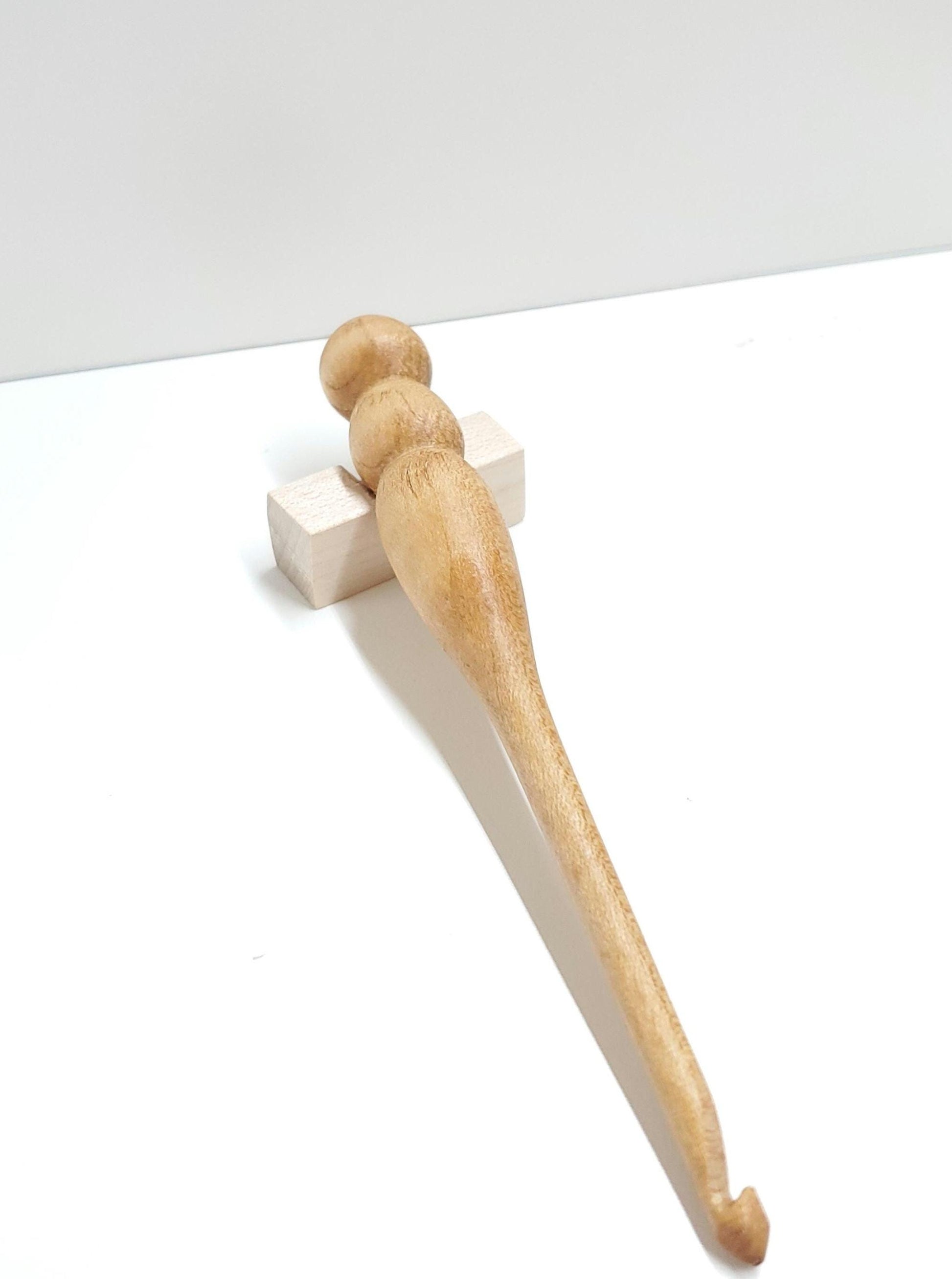 A handcrafted 5mm crochet hook made from smooth, light maple wood. Each hook is individually turned, highlighting the natural beauty and grain of the wood. While more may be made from maple, no two are exactly alike—each one is unique in its character and craftsmanship. Ergonomically shaped and polished for a comfortable, elegant crochet experience.