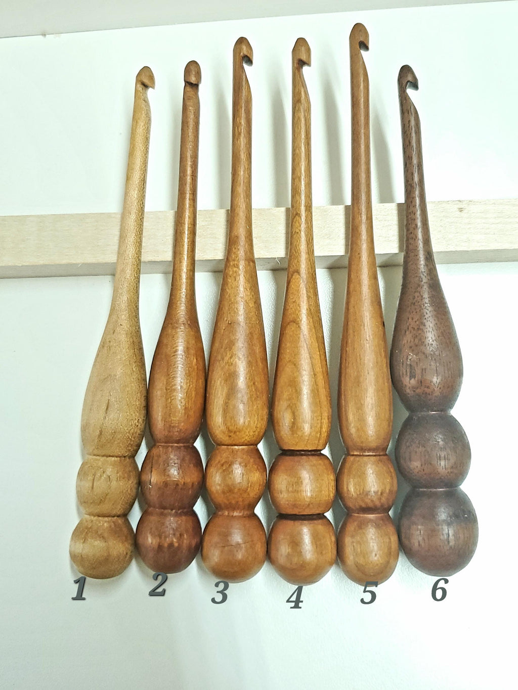 This photo features 6 individually numbered crochet hooks—use it to choose the specific hook(s) you'd like included in your bundle. Each hook is one of a kind and will not be replicated, so once it's gone, it's gone! Please list your selected number(s) or wood type(s) in the personalization box when ordering.