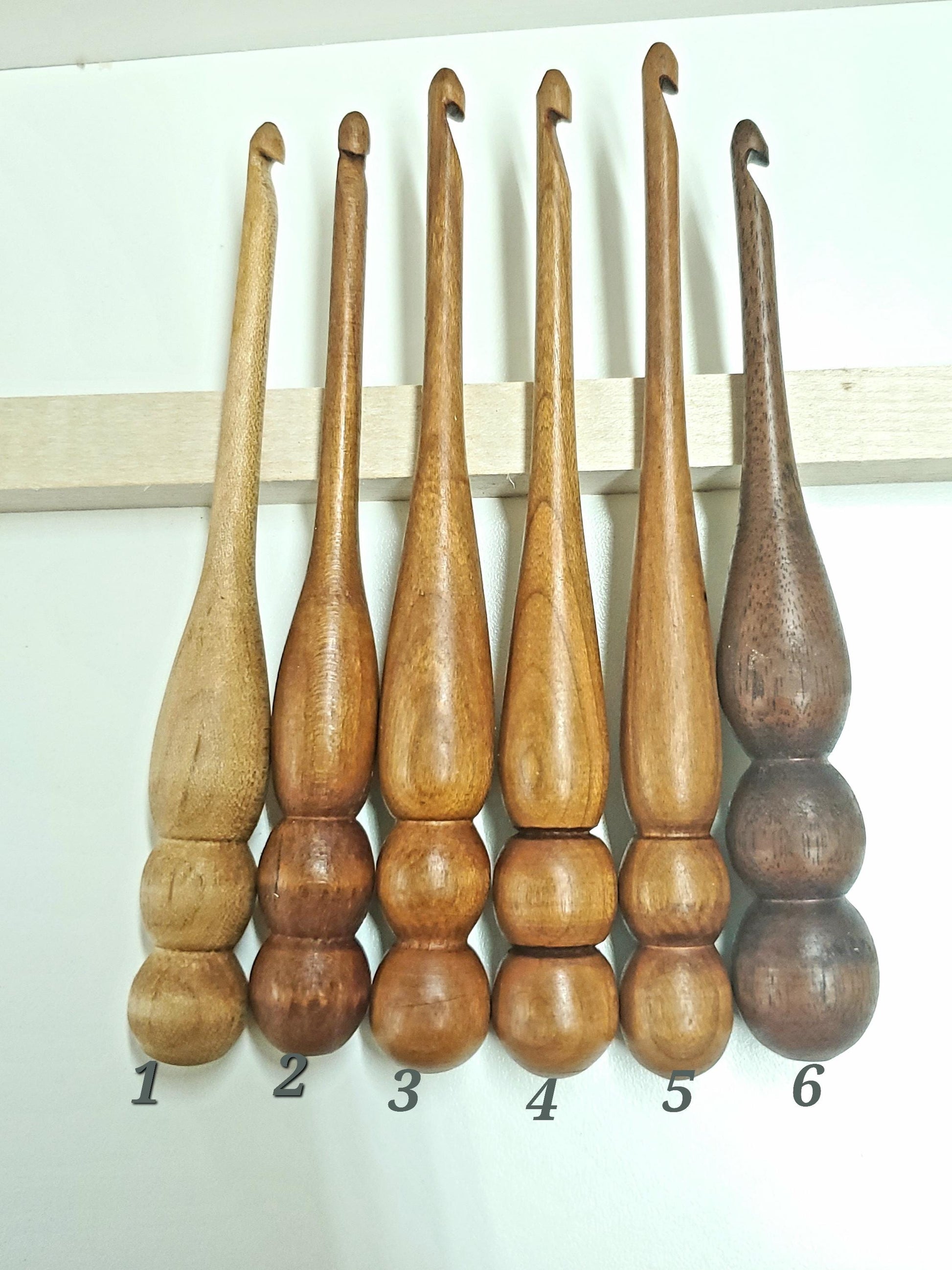 This photo features 6 individually numbered crochet hooks—use it to choose the specific hook(s) you'd like included in your bundle. Each hook is one of a kind and will not be replicated, so once it's gone, it's gone! Please list your selected number(s) or wood type(s) in the personalization box when ordering.