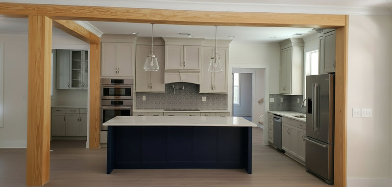 Modern kitchen with a large island and stainless steel appliances.