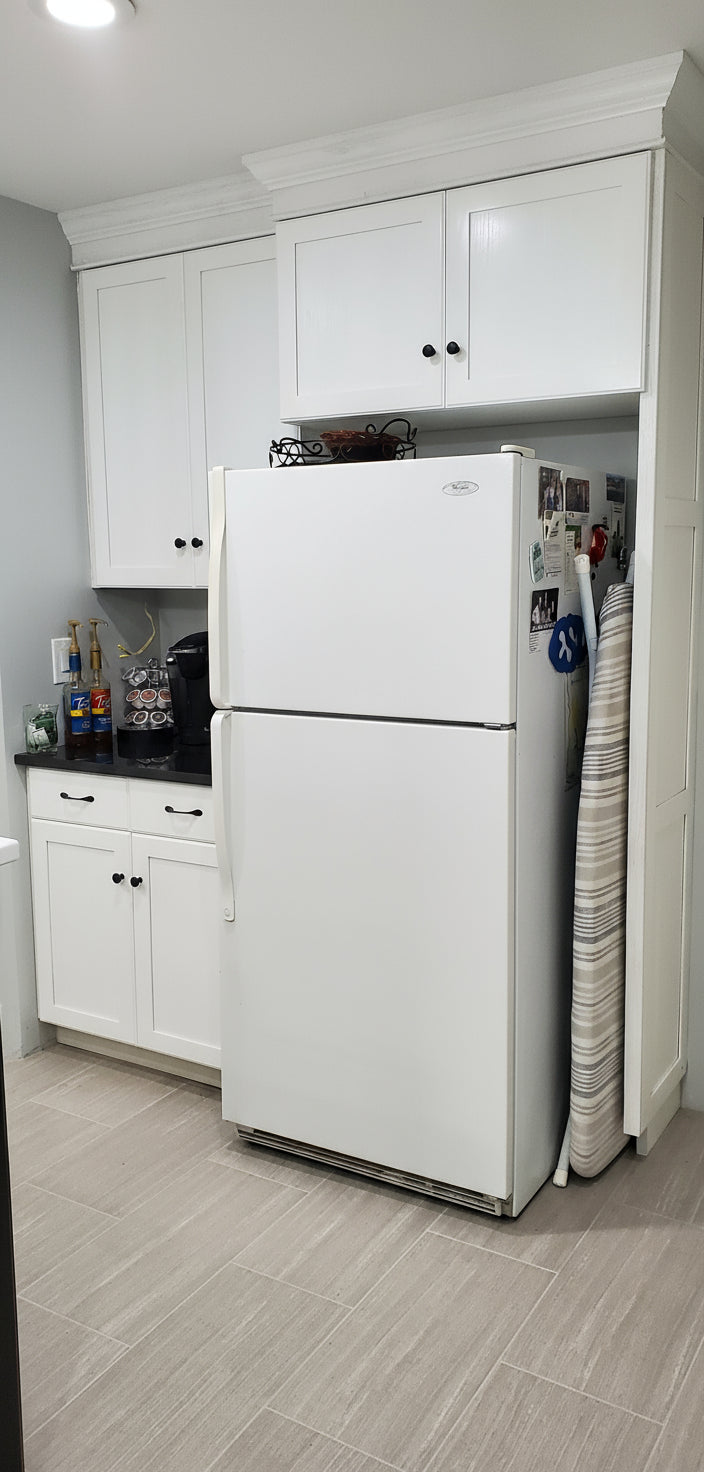 white painted oak cabinets that still show the grain with black granite countertops