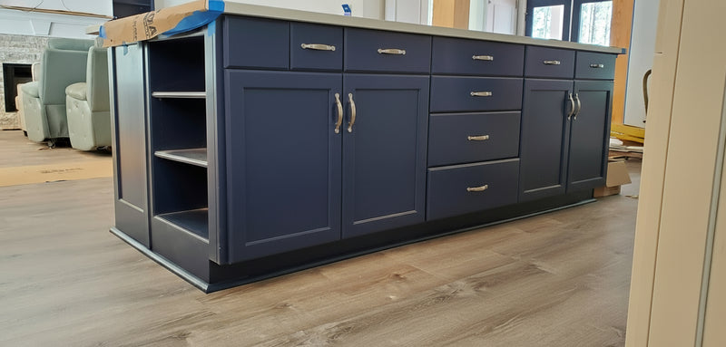 naval navy kitchen island with featuring 2 cabinets with drawers, a seating area on the back, a drawer stack and a bookshelf on the end.